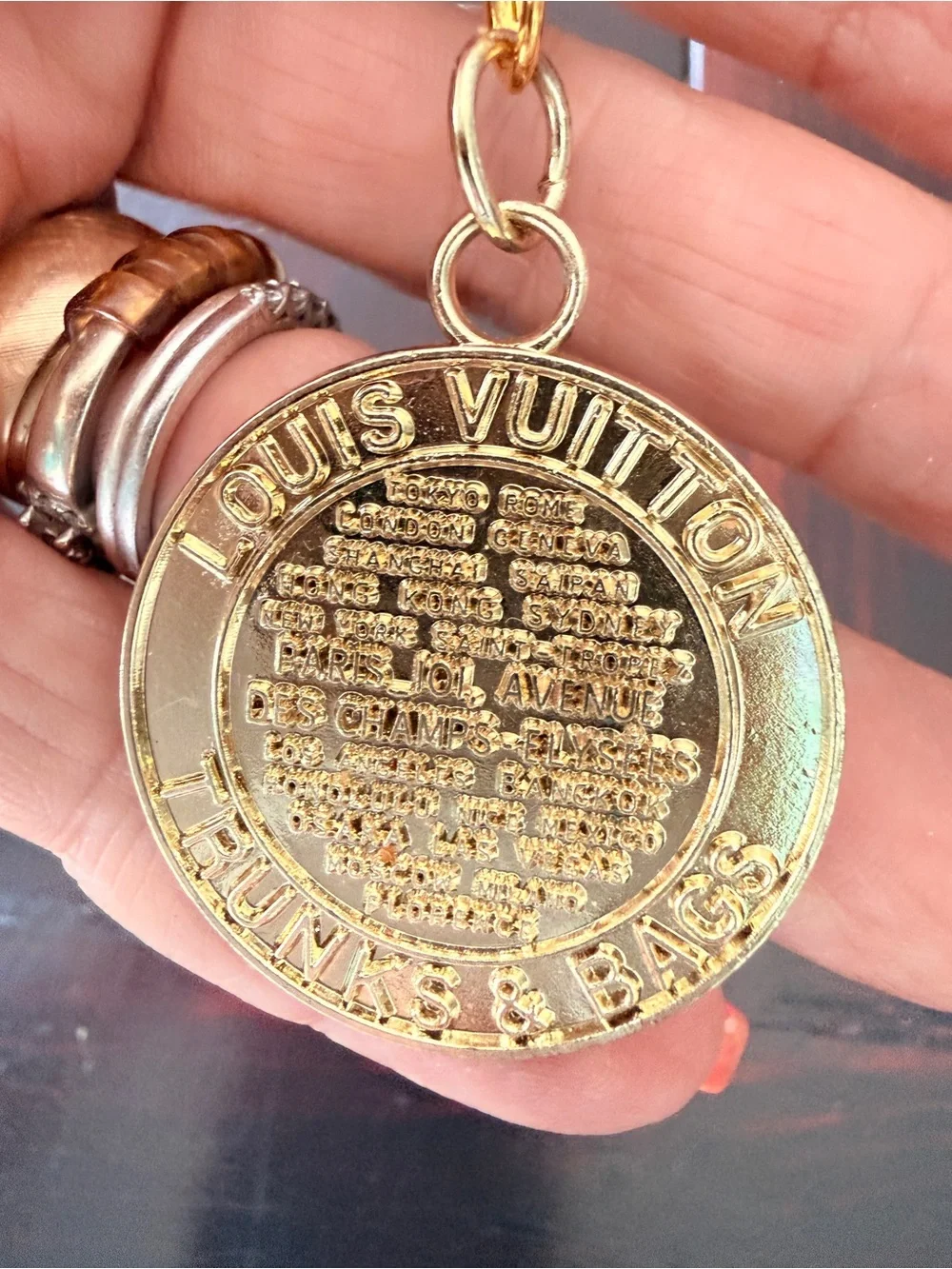 LV gold tone “trunks & bags” bag charm on a new Lobster claw swivel hook. GUC